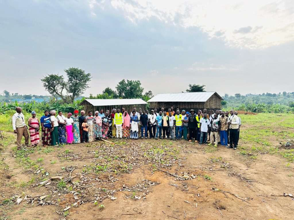 Kyebitaka community parents and teachers meeting outdoors in Kyangwali