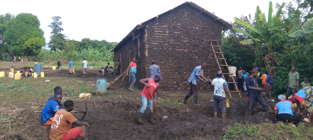 Youth volunteers mixing soil and clay
